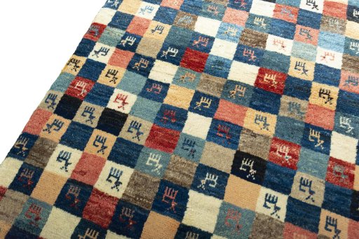 Backside of handmade 2000s Persian Gabbeh rug showing knot structure and weave density