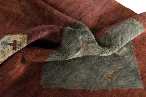 Corner detail of 2000s Persian Gabbeh rug showing border pattern and Wool pile