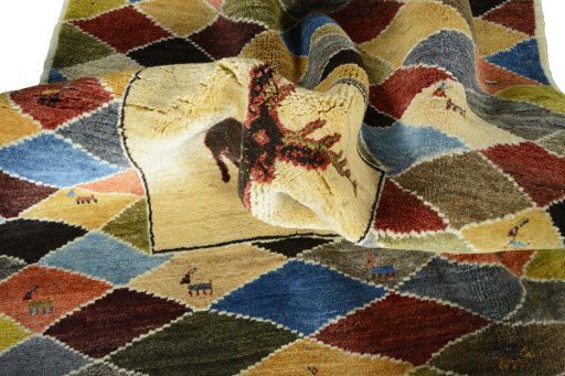 Corner detail of 2000s Persian Gabbeh rug showing border pattern and Wool pile
