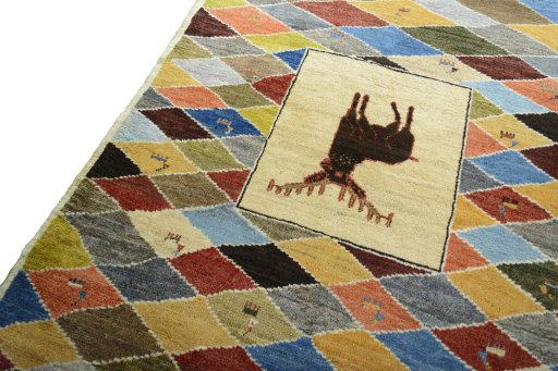 Backside of handmade 2000s Persian Gabbeh rug showing knot structure and weave density