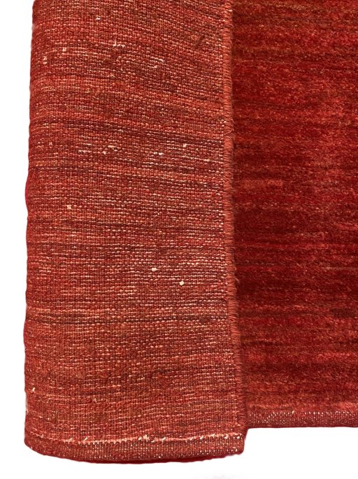 Backside of handmade New Persian Gabbeh rug showing knot structure and weave density