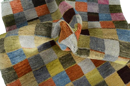 Corner detail of 2000s Persian Gabbeh rug showing border pattern and Wool pile