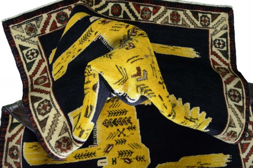 Corner detail of 2000s Persian Gabbeh rug showing border pattern and Wool pile