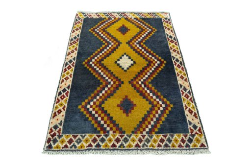 Surface texture of 2000s Persian Gabbeh rug with natural Wool and intricate pattern