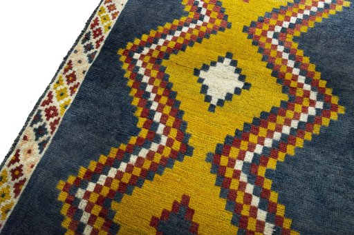 Backside of handmade 2000s Persian Gabbeh rug showing knot structure and weave density