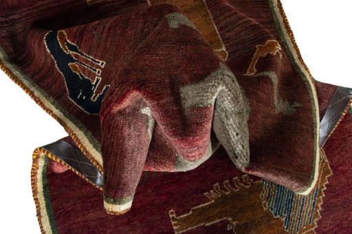 Corner detail of 2000s Persian Gabbeh rug showing border pattern and Wool pile