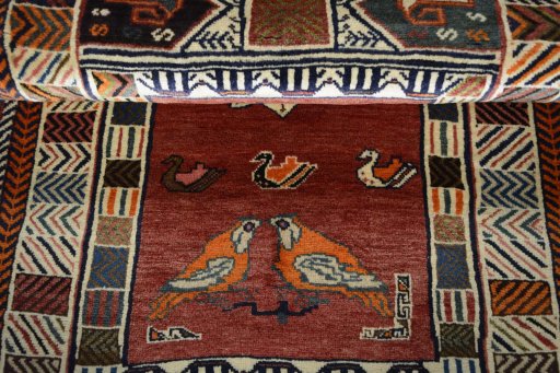 Corner detail of 2000s Persian Gabbeh rug showing border pattern and Wool pile