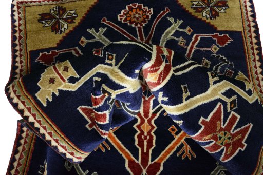 Corner detail of 2000s Persian Gabbeh rug showing border pattern and Wool pile