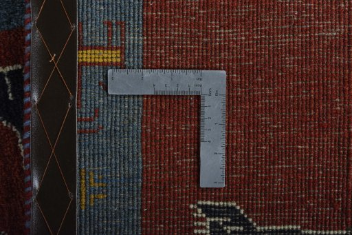 Corner detail of 2000s Persian Gabbeh rug showing border pattern and Wool pile