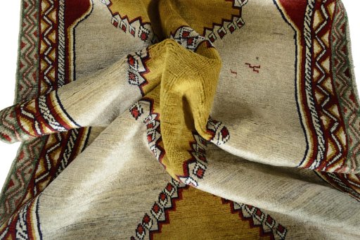 Corner detail of 2000s Persian Gabbeh rug showing border pattern and Wool pile