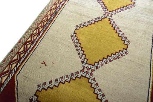 Backside of handmade 2000s Persian Gabbeh rug showing knot structure and weave density