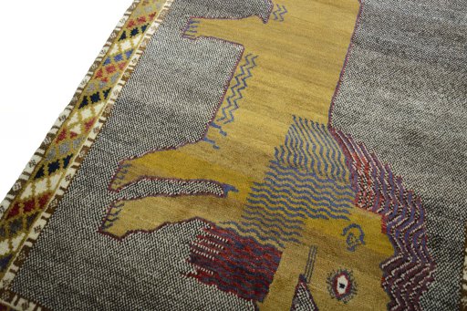 Backside of handmade 2000s Persian Gabbeh rug showing knot structure and weave density
