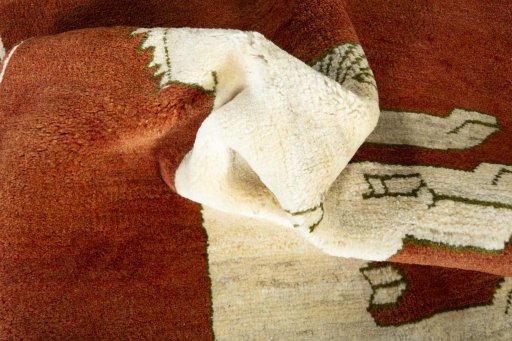 Corner detail of 2000s Persian Gabbeh rug showing border pattern and Wool pile
