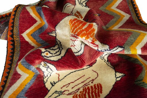 Corner detail of 2000s Persian Gabbeh rug showing border pattern and Wool pile