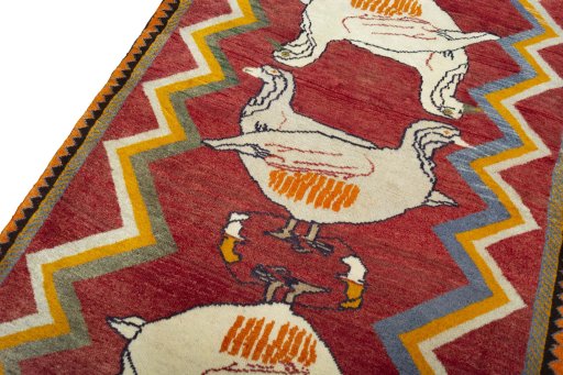 Backside of handmade 2000s Persian Gabbeh rug showing knot structure and weave density