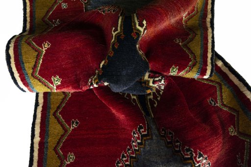 Corner detail of 2000s Persian Gabbeh rug showing border pattern and Wool pile
