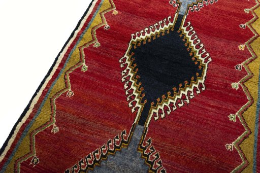 Backside of handmade 2000s Persian Gabbeh rug showing knot structure and weave density