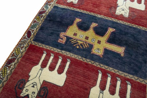 Backside of handmade 2000s Persian Gabbeh rug showing knot structure and weave density