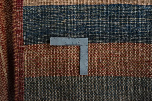 Corner detail of 2000s Persian Gabbeh rug showing border pattern and Wool pile