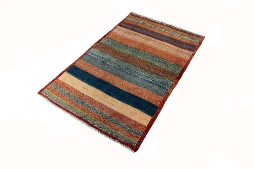 Corner detail of 2000s Persian Gabbeh rug showing border pattern and Wool pile