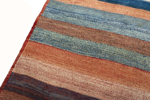 Backside of handmade 2000s Persian Gabbeh rug showing knot structure and weave density