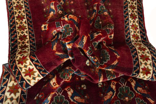 Corner detail of 2000s Persian Gabbeh rug showing border pattern and Wool pile