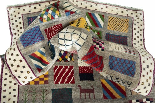 Corner detail of 2000s Persian Gabbeh rug showing border pattern and Wool pile