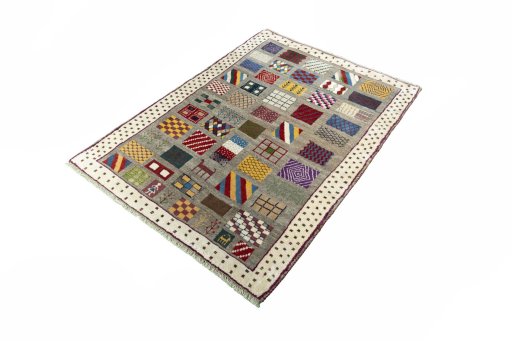 Corner detail of 2000s Persian Gabbeh rug showing border pattern and Wool pile