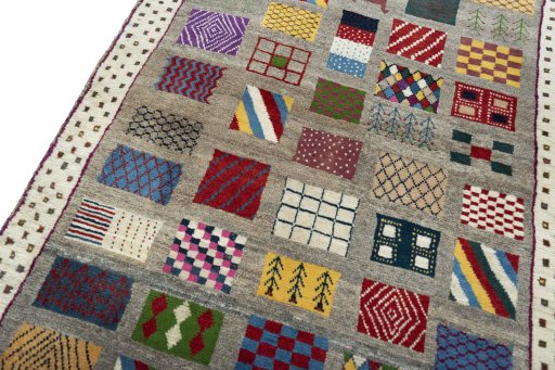 Backside of handmade 2000s Persian Gabbeh rug showing knot structure and weave density
