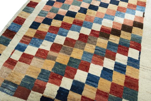 Backside of handmade 2000s Persian Gabbeh rug showing knot structure and weave density