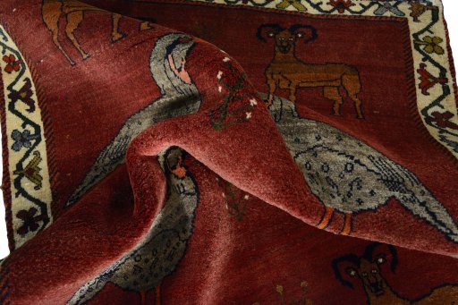 Corner detail of 2000s Persian Gabbeh rug showing border pattern and Wool pile