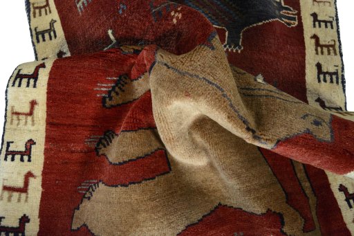 Corner detail of 2000s Persian Gabbeh rug showing border pattern and Wool pile