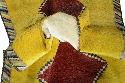 Corner detail of 2000s Persian Gabbeh rug showing border pattern and Wool pile