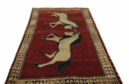 Surface texture of 2000s Persian Gabbeh rug with natural Wool and intricate pattern