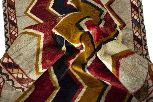 Corner detail of 2000s Persian Gabbeh rug showing border pattern and Wool pile