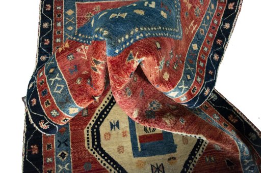 Corner detail of 2000s Persian Gabbeh rug showing border pattern and Wool pile