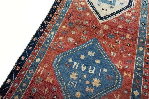 Backside of handmade 2000s Persian Gabbeh rug showing knot structure and weave density