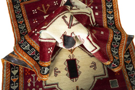 Corner detail of 2000s Persian Gabbeh rug showing border pattern and Wool pile
