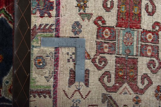 Surface texture of 2000s Persian Gabbeh rug with natural Wool and intricate pattern