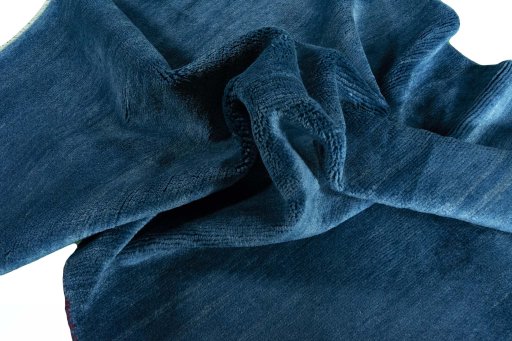Corner detail of New Persian Gabbeh rug showing border pattern and Wool pile
