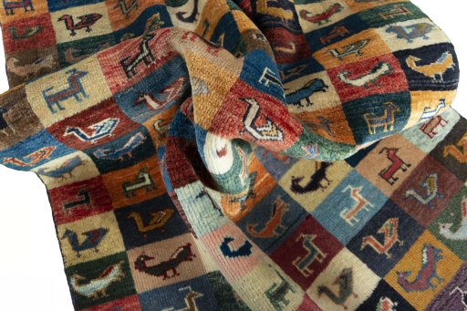 Corner detail of 2000s Persian Gabbeh rug showing border pattern and Wool pile
