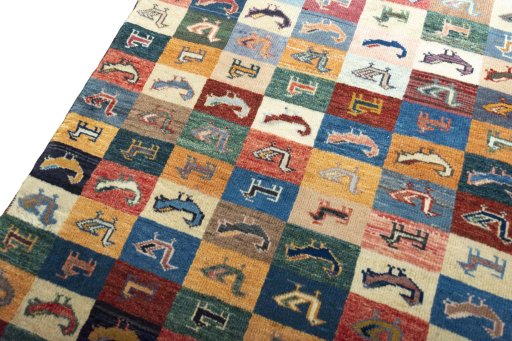 Backside of handmade 2000s Persian Gabbeh rug showing knot structure and weave density