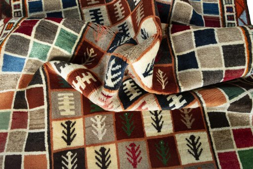 Corner detail of 2000s Persian Gabbeh rug showing border pattern and Wool pile