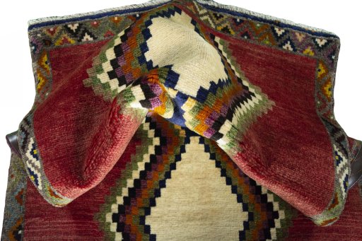 Corner detail of 2000s Persian Gabbeh rug showing border pattern and Wool pile