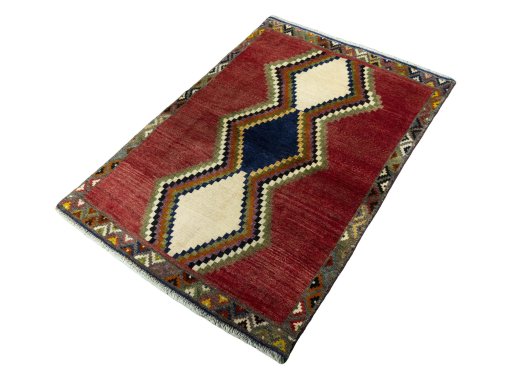 Corner detail of 2000s Persian Gabbeh rug showing border pattern and Wool pile