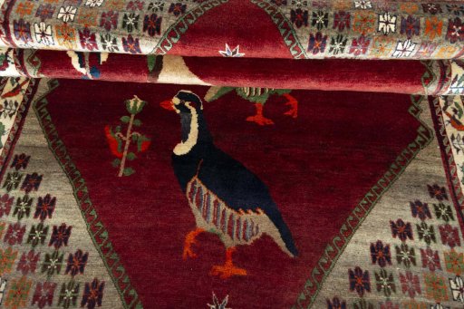Corner detail of 2000s Persian Gabbeh rug showing border pattern and Wool pile