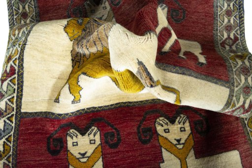 Corner detail of 2000s Persian Gabbeh rug showing border pattern and Wool pile
