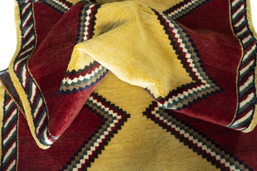Corner detail of 2000s Persian Gabbeh rug showing border pattern and Wool pile