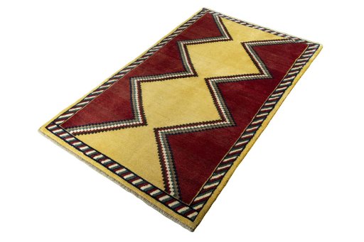 Corner detail of 2000s Persian Gabbeh rug showing border pattern and Wool pile