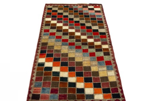 Surface texture of 2000s Persian Gabbeh rug with natural Wool and intricate pattern